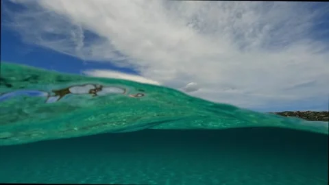 Half underwater view of man on standup paddleboard Stock Footage 278954340