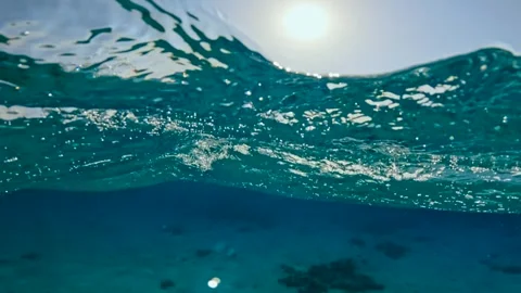 Half underwater view of rough sea waves and anchored yachts in the horizon Stock Footage 340541267