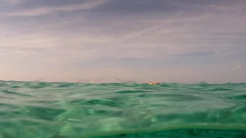 Half underwater view of sailing ship and clear seawater with rocks Stock-Footage 279894288