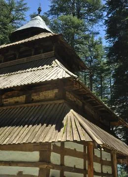 Half view of famous Hadimba Devi Temple in Manali, Himachal Pradesh, India  Stock Photos
