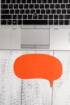 Half view trendy open laptop blank speech bubble facing downwards lying vintage Stock Photos