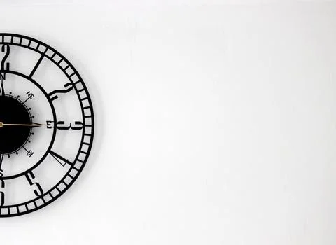A half of the wall clock placed in the left side of the background to create a b Stock Photos