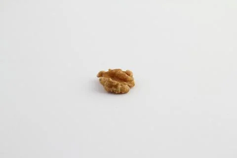 Half a walnut shelled on a white background Stock Photos