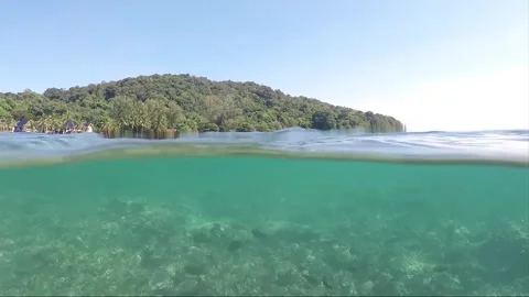 Half water split shot, School of Fish on Coral reef, Perhentian Island, Malaysia Stock Footage 197587172
