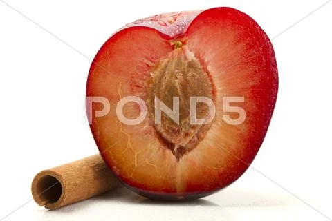 Half wet plum with a cinnamon stick Stock Photos