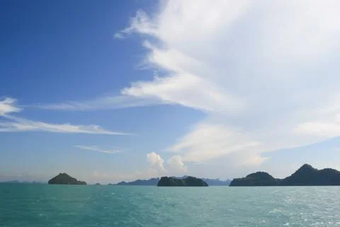 Half white cloud and blue sky in a sea summer Stock Photos