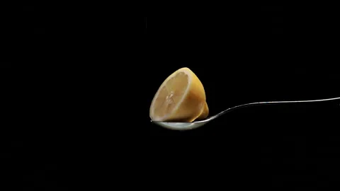 Half a yellow lemon sprinkled in slow motion with white sugar Stock Footage 131406249