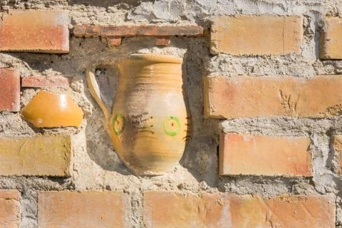 Halfway immured ceramic jar Stock Photos