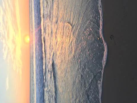 Halfway through beach sunset Stock Photos