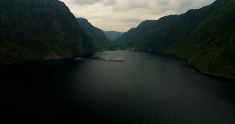 Halibut fish farm in dramatic Norwegian fjord, Norway. Aerial backward Stock Footage 318529774
