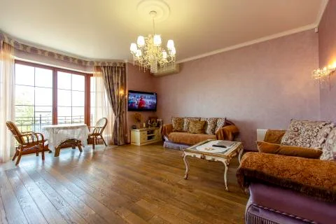 Hall in classic style with two sofas, coffee table, TV. A round table and two Stock Photos