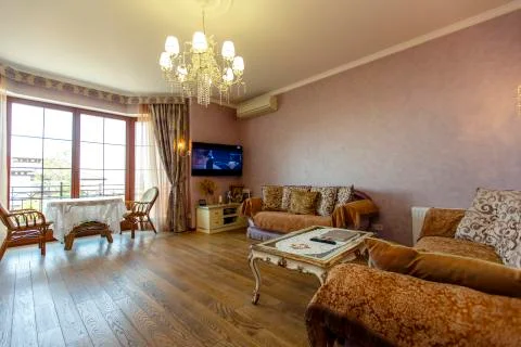 Hall in classic style with two sofas, coffee table, TV. A round table and two Stock Photos