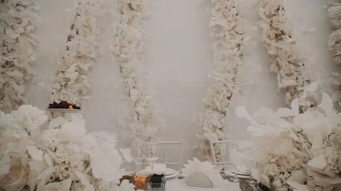 Hall decor with a white table decorated with flowers Stock Footage 119029916