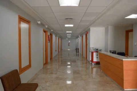 Hall in the hospital, white walls and brown doors. Stock Photos