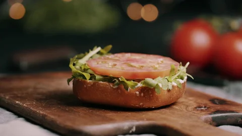 Halloumi Being Placed On Hamburger Bun With Tomato and Rocket Video stock 134402726
