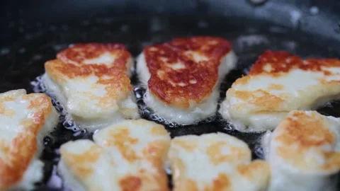 Halloumi cheese Sizzles in pan Stock Footage 166863318
