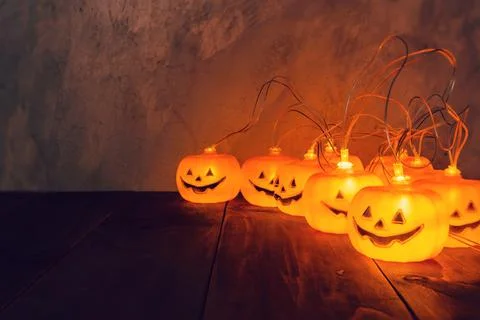 Halloween background, Pumpkin String Lights On Wooden Table Stock Photos