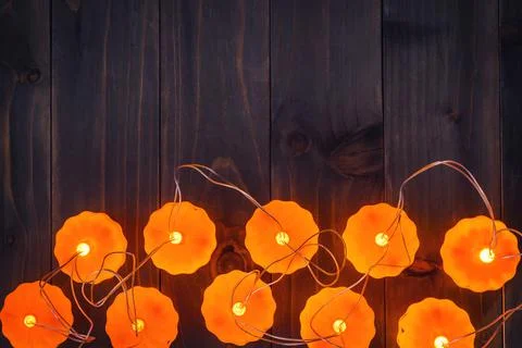Halloween background, Pumpkin String Lights On Wooden Table Stock Photos