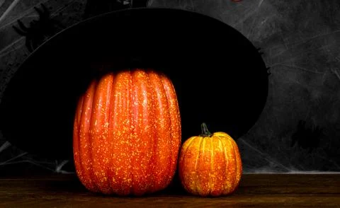 Halloween background with pumpkin with witch hat against dark background. Ban Stock Photos