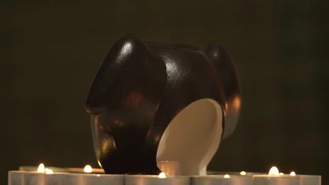 Halloween bat devil monster head with scary grin and burning candle inside Video stock 251524389