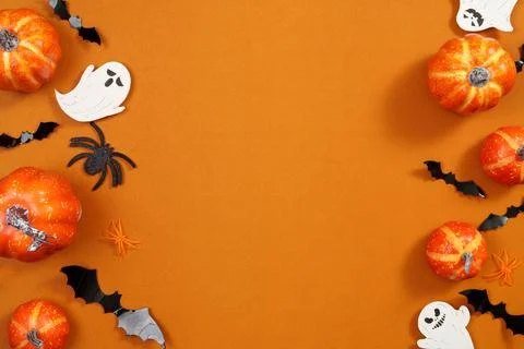 Halloween border frame with pumpkins ghosts and bats on orange background with Stock Photos