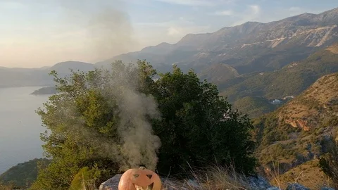 Halloween Burning Pumpkin looking through the green smoke 스톡 동영상 97605491