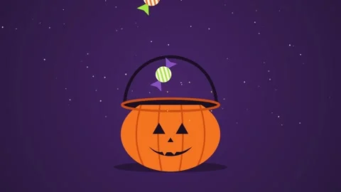 Halloween candy falling into a jack o lantern trick or treat bucket Stock Footage 347895640