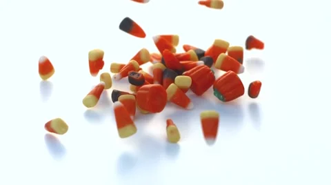 Halloween candy falling on a white table in slow motion Stock Footage 54638087