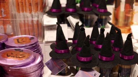 Halloween candy gifts decorated with tiny witch hats and displayed among colorfu Video stock 346305233