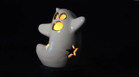 Halloween ceramic ghost slowly rotating with internal candle Stock Footage 67961305