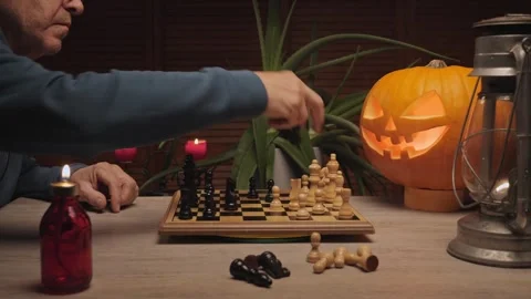 Halloween chess match with glowing pumpkin Stock Footage 320041227