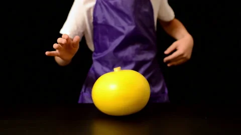 Halloween, childrens hands close-up rotate a pumpkin on the table. Stock Footage 166704547