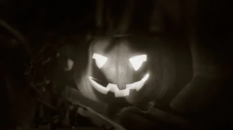 Halloween clip - scary pumpkin and moving through the shadows of the tress Stock Footage