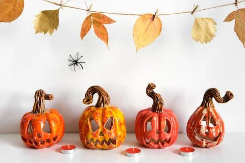 Halloween composition with ceramic pumpkins jack lantern and candles on table Stock Photos