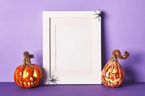 Halloween composition with ceramic pumpkins jack lantern and frame on table w Stock Photos