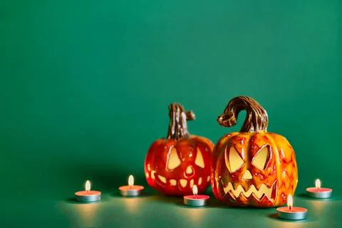 Halloween composition with diy ceramic pumpkins jack lantern and candles on pine Stock-Fotos
