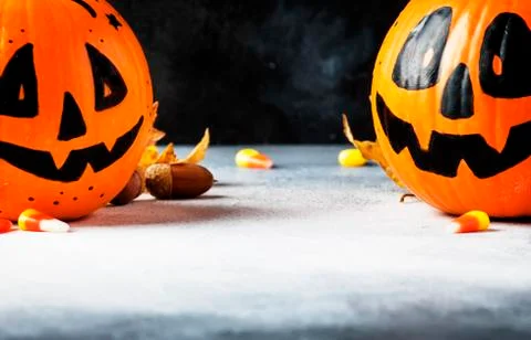 Halloween composition with pumpkins lanterns, with fallen leaves on a dark ba Stock Photos