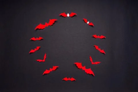 Halloween composition. Round frame made of red bats on black background. Happ Stock Photos