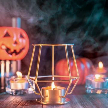 Halloween concept, orange pumpkin lantern and candles on a dark wooden tabl.. Stock Illustration