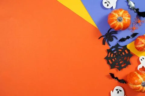 Halloween corner composition with pumpkins ghosts spiderweb and bats on colorful Stock Photos