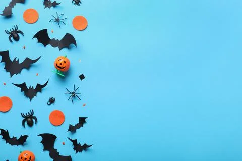 Halloween decor elements on light blue background, flat lay. Space for text Stock Photos