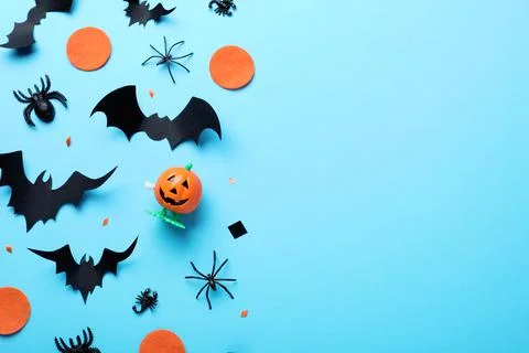 Halloween decor elements on light blue background, flat lay. Space for text Stock Photos
