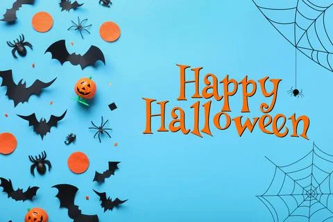 Halloween decor elements on light blue background, flat lay Stock Photos