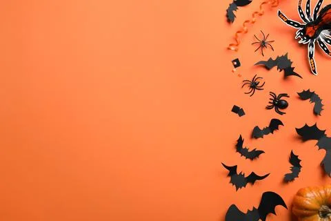 Halloween decor elements on orange background, flat lay. Space for text Stock Photos