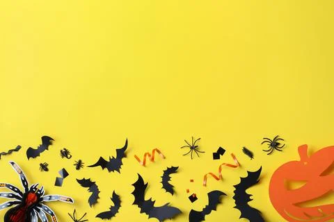 Halloween decor elements on yellow background, flat lay. Space for text Stock Photos
