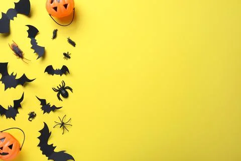 Halloween decor elements on yellow background, flat lay. Space for text Stock Photos