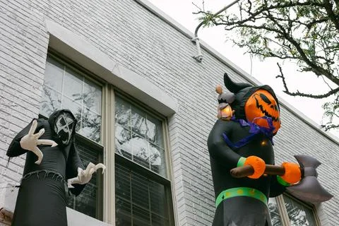 Halloween decorations featuring inflatable characters on a building in a festive Stock Photos