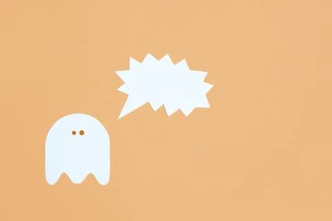 Halloween design, white cute ghost with a blank speech bubble on pastel orang Stock Illustration