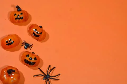 Halloween double border of scattered candy and decor. Flat lay over an oran.. Stock Photos