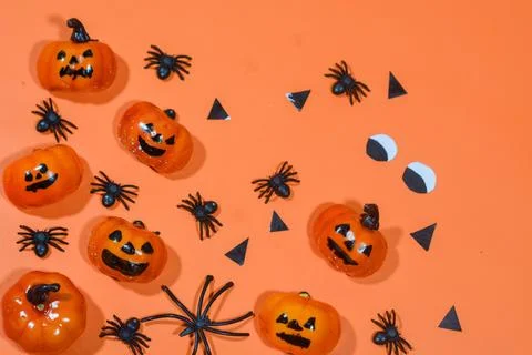 Halloween double border of scattered candy and decor. Flat lay over an oran.. Stock Photos